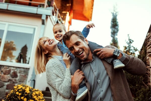 Personal Insurance - Mother and Father Holding Their Small Child While Outside